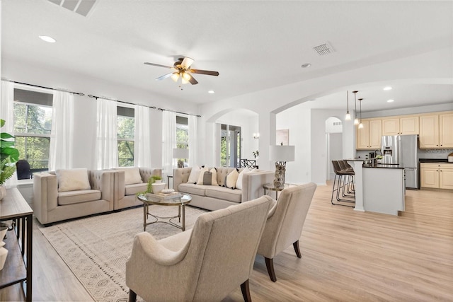 3868 Whitewood Ct, Oviedo, FL 32766 - living room featuring arched walkways, light wood-style flooring, ceiling fan, and recessed lighting