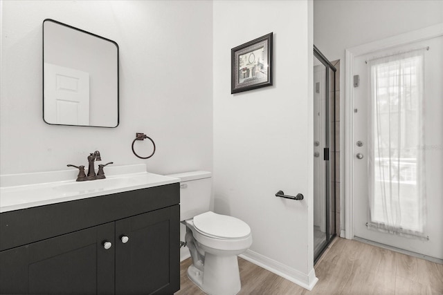 3868 Whitewood Ct, Oviedo, FL 32766 - bathroom featuring wood finished floors, vanity, toilet, a shower stall, and baseboards