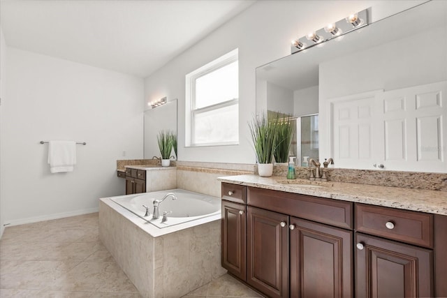 3868 Whitewood Ct, Oviedo, FL 32766 - bathroom featuring vanity, a stall shower, a bath, tile patterned flooring, and baseboards