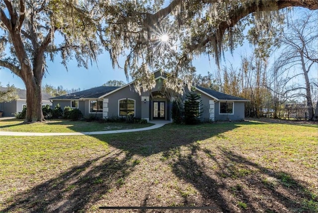 6917 Roman Ct, Clermont, FL 34714 - single story home with french doors, a front yard, and stucco siding