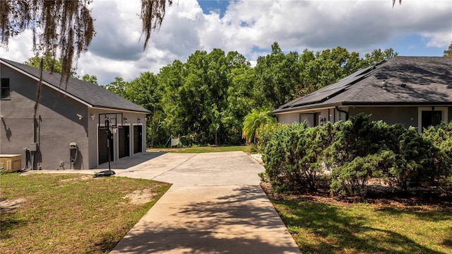 6917 Roman Ct, Clermont, FL 34714 - view of green lawn with concrete driveway and a garage