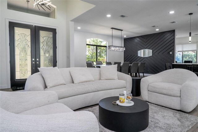 6917 Roman Ct, Clermont, FL 34714 - living area featuring a chandelier, recessed lighting, healthy amount of natural light, an accent wall, and wood finished floors