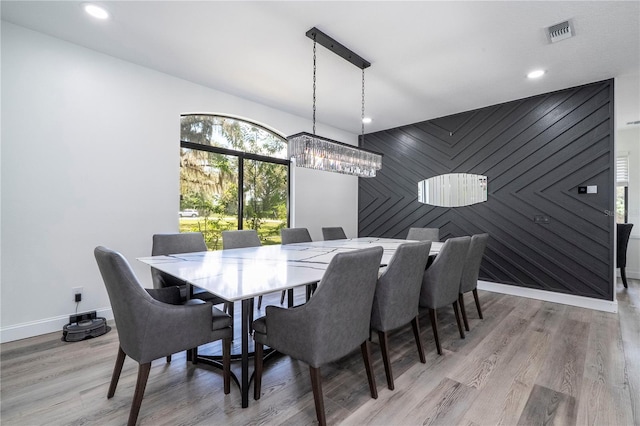 6917 Roman Ct, Clermont, FL 34714 - dining room featuring an accent wall, baseboards, light wood-style flooring, and recessed lighting