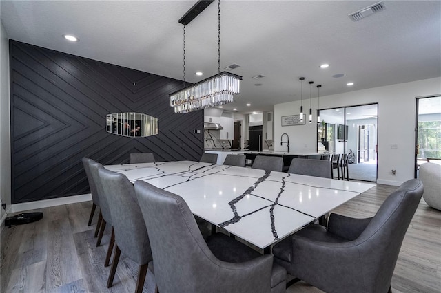 6917 Roman Ct, Clermont, FL 34714 - dining space with baseboards, light wood finished floors, recessed lighting, and a chandelier
