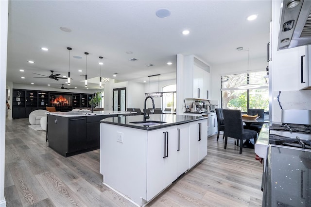 6917 Roman Ct, Clermont, FL 34714 - kitchen featuring a sink, a kitchen island with sink, recessed lighting, range hood, and open floor plan