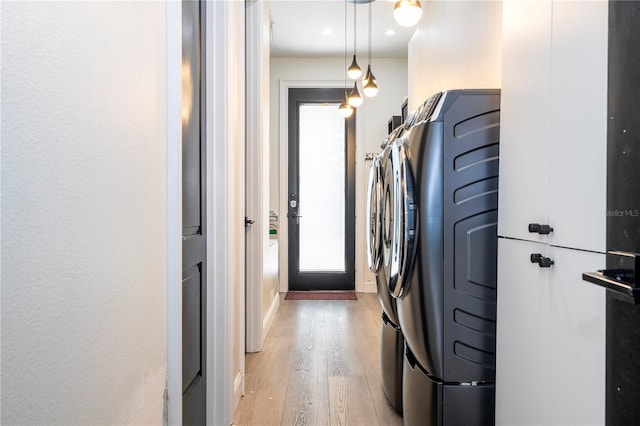6917 Roman Ct, Clermont, FL 34714 - washroom with light wood-style floors and separate washer and dryer