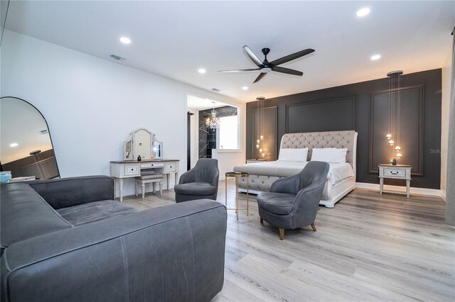 6917 Roman Ct, Clermont, FL 34714 - bedroom featuring light wood finished floors, recessed lighting, ceiling fan, and a chandelier