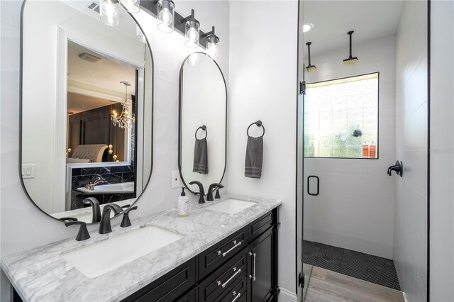 6917 Roman Ct, Clermont, FL 34714 - full bath with a shower stall, double vanity, a chandelier, and wood finished floors