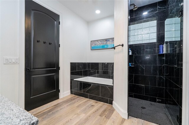 6917 Roman Ct, Clermont, FL 34714 - bathroom featuring a stall shower, a bath, wood finished floors, and recessed lighting
