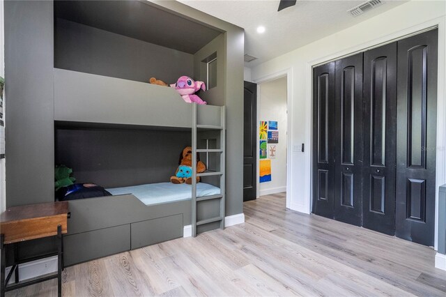 6917 Roman Ct, Clermont, FL 34714 - bedroom featuring wood finished floors, baseboards, and a closet