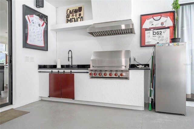 6917 Roman Ct, Clermont, FL 34714 - kitchen with freestanding refrigerator, wall chimney exhaust hood, a textured wall, a sink, and open shelves