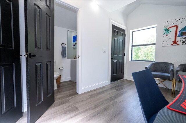 6917 Roman Ct, Clermont, FL 34714 - home office with light wood-style flooring, baseboards, and lofted ceiling