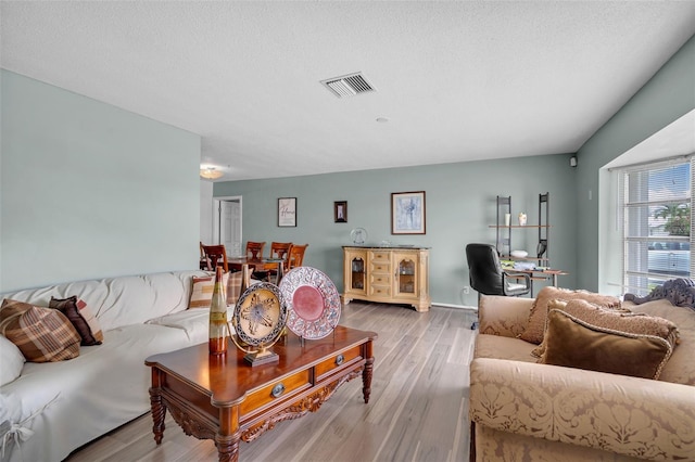 7500 NW 66th Ter, Tamarac, FL 33321 - living room with wood finished floors, a desk, and a textured ceiling