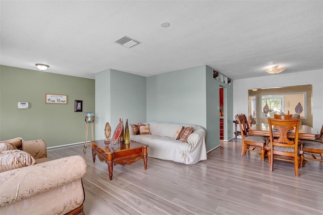 7500 NW 66th Ter, Tamarac, FL 33321 - living room with wood finished floors, a textured ceiling, and baseboards