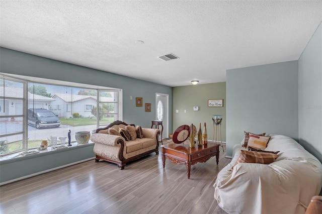 7500 NW 66th Ter, Tamarac, FL 33321 - living room featuring wood finished floors and a textured ceiling
