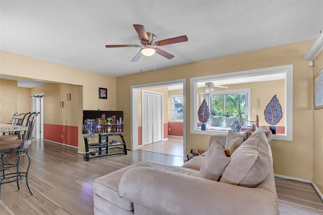 7500 NW 66th Ter, Tamarac, FL 33321 - living room with light wood finished floors, baseboards, and a ceiling fan
