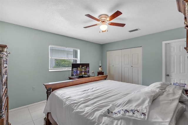 7500 NW 66th Ter, Tamarac, FL 33321 - bedroom featuring light tile patterned floors, a closet, a ceiling fan, a textured ceiling, and baseboards