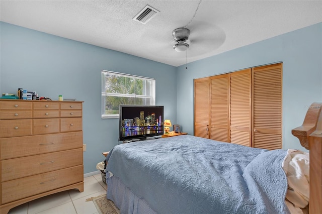 7500 NW 66th Ter, Tamarac, FL 33321 - bedroom featuring a closet, light tile patterned floors, a ceiling fan, a textured ceiling, and baseboards