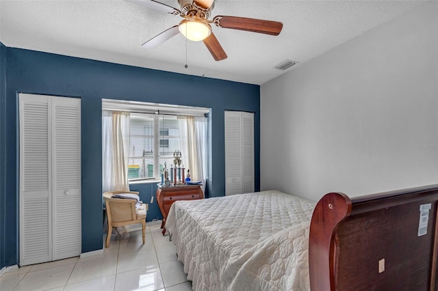 7500 NW 66th Ter, Tamarac, FL 33321 - bedroom with light tile patterned floors, ceiling fan, a textured ceiling, and multiple closets
