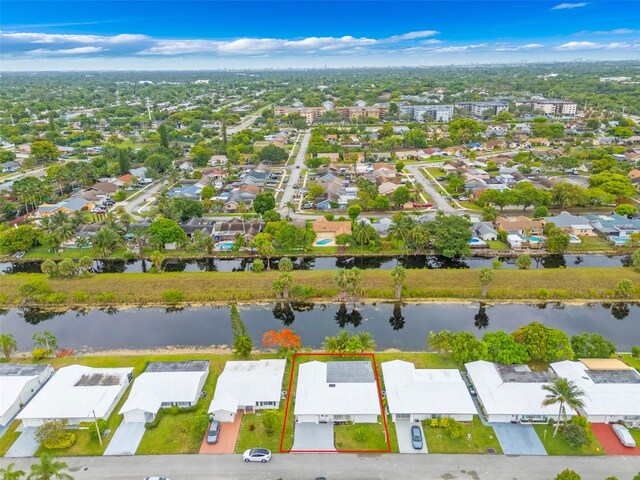 7500 NW 66th Ter, Tamarac, FL 33321 - aerial view of residential area with property boundaries highlighted and a nearby body of water