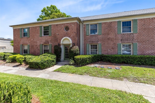 117 Georgetown Dr Unit C, Casselberry, FL 32707 - view of front facade featuring brick siding and a front yard