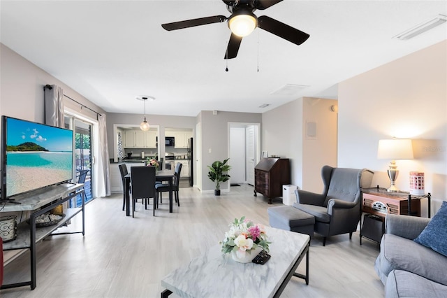 117 Georgetown Dr Unit C, Casselberry, FL 32707 - living room with light wood-style flooring and ceiling fan