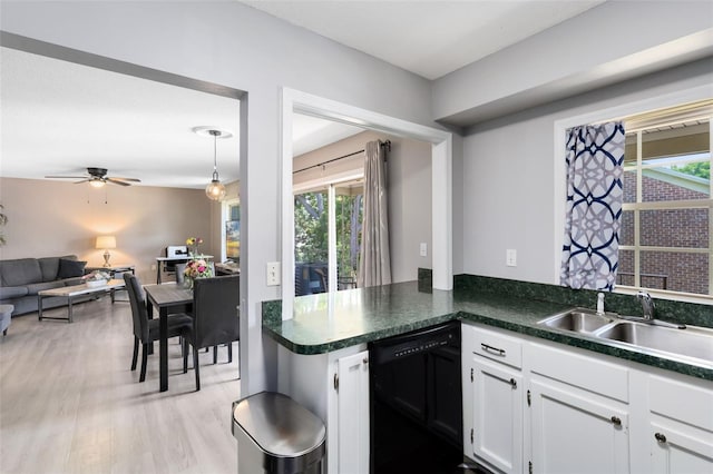 117 Georgetown Dr Unit C, Casselberry, FL 32707 - kitchen featuring black dishwasher, a sink, plenty of natural light, and dark countertops
