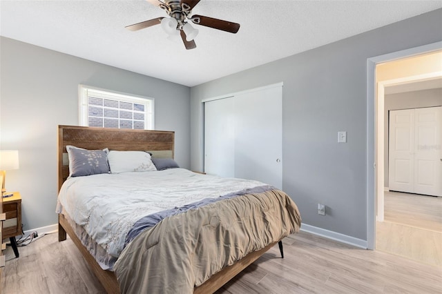 117 Georgetown Dr Unit C, Casselberry, FL 32707 - bedroom featuring light wood-style floors, a closet, baseboards, ceiling fan, and a textured ceiling