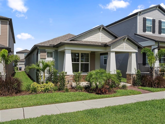 12009 Walmsley Aly, Winter Garden, FL 34787 - craftsman house featuring stone siding, a shingled roof, and stucco siding
