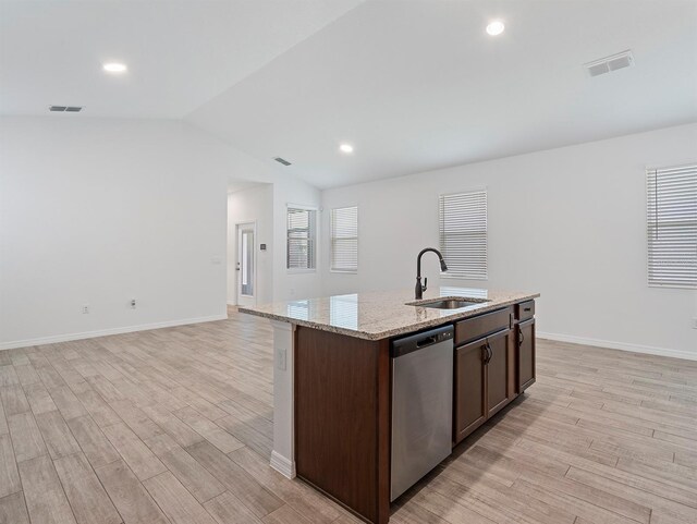 12009 Walmsley Aly, Winter Garden, FL 34787 - kitchen featuring dishwasher, a sink, light wood-style flooring, lofted ceiling, and a center island with sink