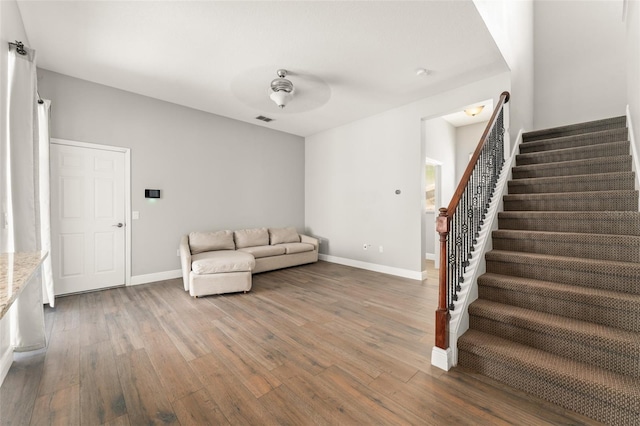 5032 Beach River Rd, Windermere, FL 34786 - unfurnished living room featuring wood finished floors, stairway, and baseboards