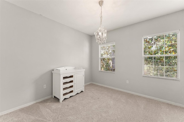 5032 Beach River Rd, Windermere, FL 34786 - spare room featuring light colored carpet, a chandelier, and baseboards