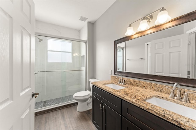 5032 Beach River Rd, Windermere, FL 34786 - bathroom featuring toilet, a stall shower, wood finished floors, and double vanity