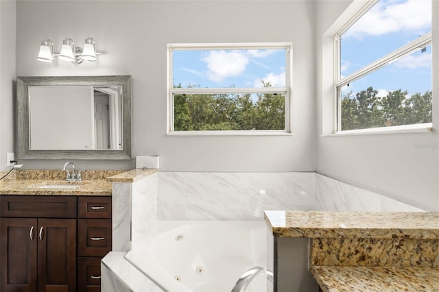 5032 Beach River Rd, Windermere, FL 34786 - bathroom featuring a tub with jets and vanity