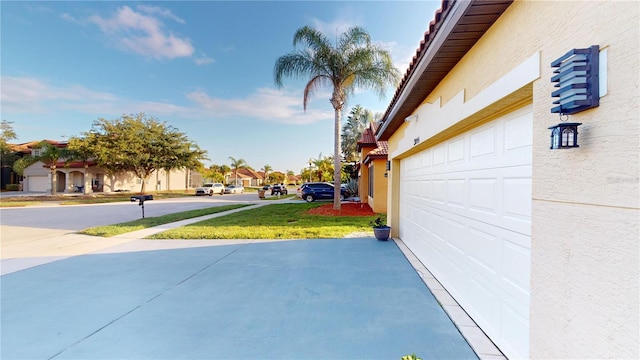 3044 Camino Real Dr S, Kissimmee, FL 34744 - view of patio featuring a garage, concrete driveway, and a residential view