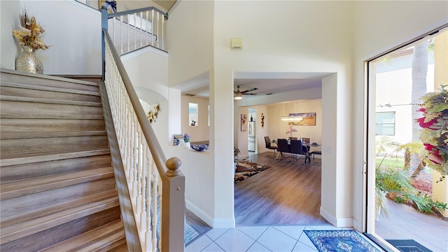 3044 Camino Real Dr S, Kissimmee, FL 34744 - staircase featuring tile patterned flooring, a ceiling fan, and a high ceiling