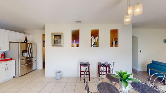 3044 Camino Real Dr S, Kissimmee, FL 34744 - dining area featuring arched walkways and light tile patterned floors