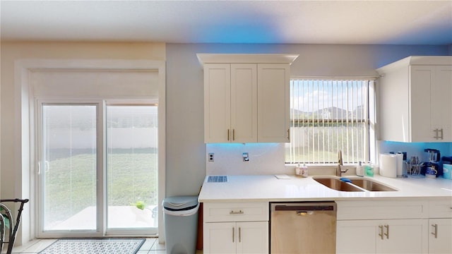 3044 Camino Real Dr S, Kissimmee, FL 34744 - kitchen featuring dishwasher, light countertops, and white cabinets