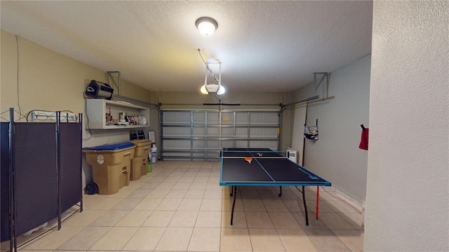 3044 Camino Real Dr S, Kissimmee, FL 34744 - playroom featuring a garage, a textured ceiling, and light tile patterned floors