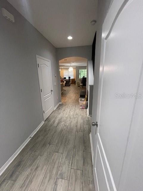 2937 Econ Landing Blvd, Orlando, FL 32825 - hallway with arched walkways, wood finished floors, baseboards, and recessed lighting