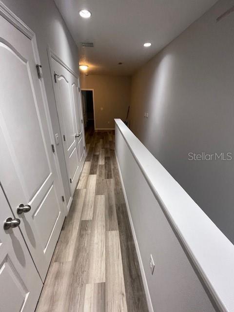2937 Econ Landing Blvd, Orlando, FL 32825 - hallway featuring light wood-style floors, recessed lighting, an upstairs landing, and baseboards