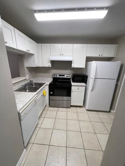 2236 Stonington Ave Unit 2236, Orlando, FL 32817 - kitchen featuring white appliances, under cabinet range hood, a sink, and white cabinets