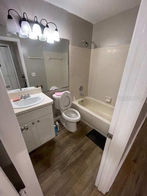 2236 Stonington Ave Unit 2236, Orlando, FL 32817 - full bathroom with toilet, wood finished floors, tub / shower combination, vanity, and a textured ceiling
