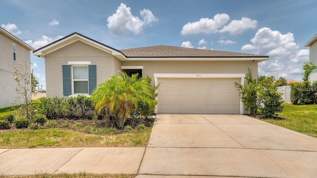 600 Buchannan Dr, Davenport, FL 33837 - view of front of home featuring a garage, stucco siding, and concrete driveway