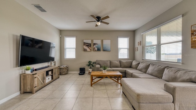 600 Buchannan Dr, Davenport, FL 33837 - living room with healthy amount of natural light, a ceiling fan, baseboards, and light tile patterned floors
