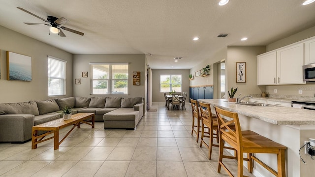 600 Buchannan Dr, Davenport, FL 33837 - living area with recessed lighting, a ceiling fan, light tile patterned floors, and a textured ceiling