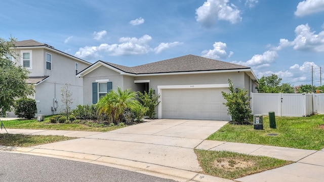 600 Buchannan Dr, Davenport, FL 33837 - view of front facade with a garage, stucco siding, concrete driveway, roof with shingles, and a gate