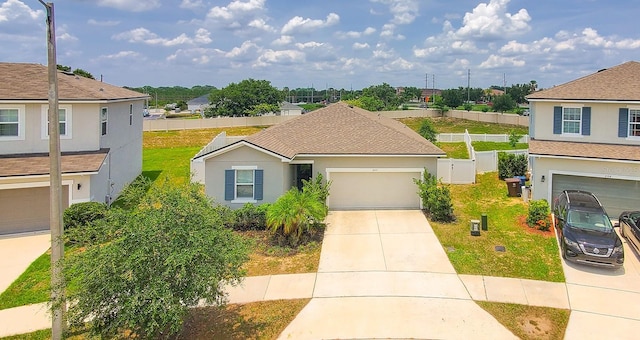 600 Buchannan Dr, Davenport, FL 33837 - traditional-style house with driveway, a shingled roof, an attached garage, and a residential view