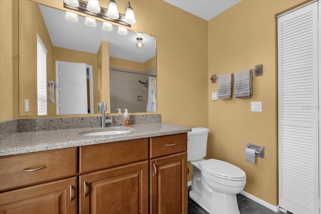 2344 Whispering Maple Dr, Orlando, FL 32837 - bathroom featuring a closet, toilet, vanity, baseboards, and tile patterned flooring