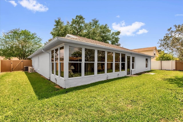 2344 Whispering Maple Dr, Orlando, FL 32837 - back of property featuring a gate, stucco siding, and central AC